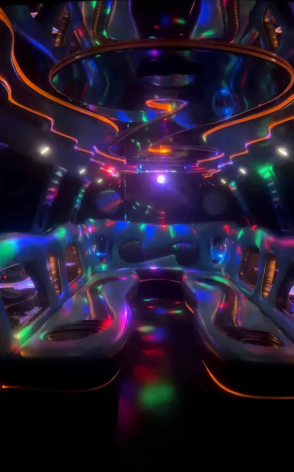 Luxury stretch limousine interior with ambient multicolour lighting and leather bench seating